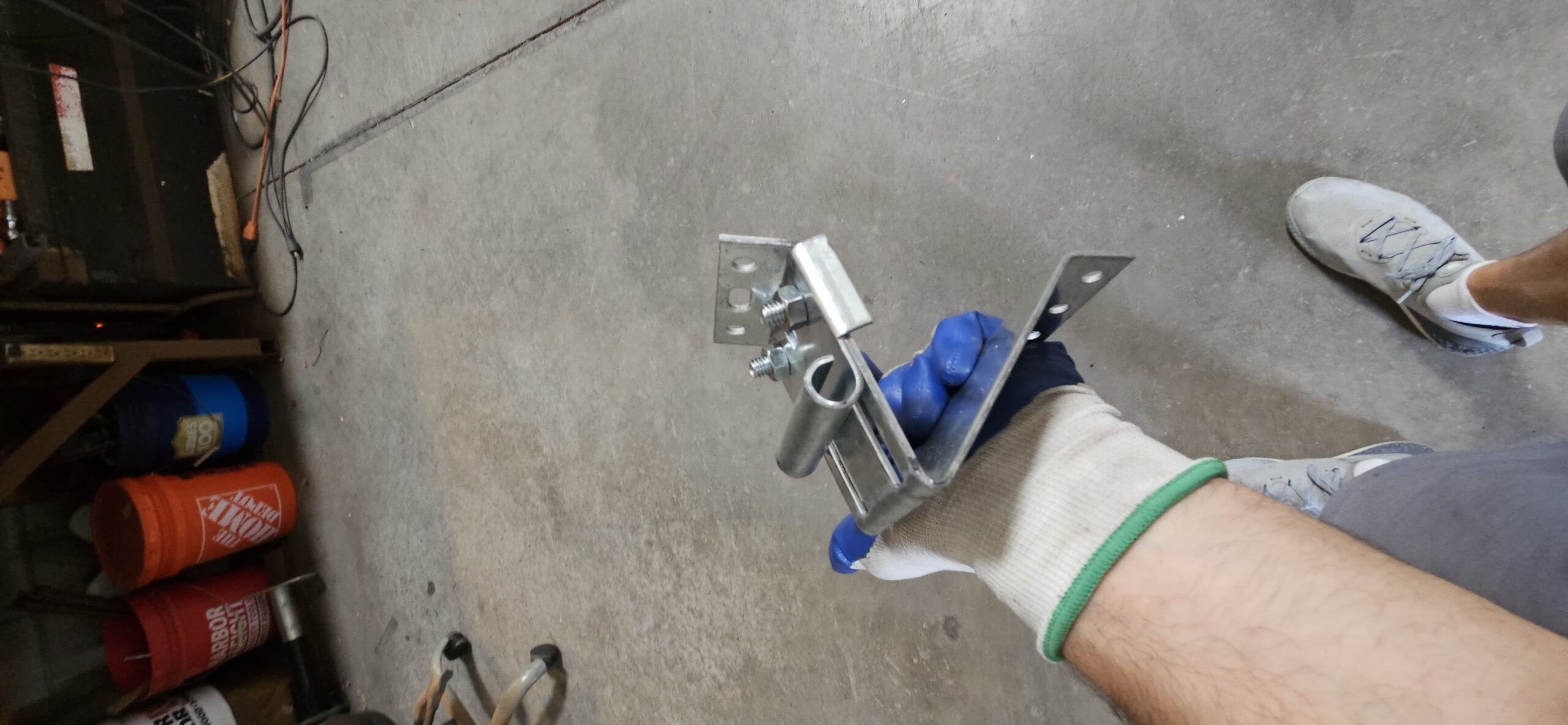 New upper roller bracket prepared for commercial garage door repair in Goodyear