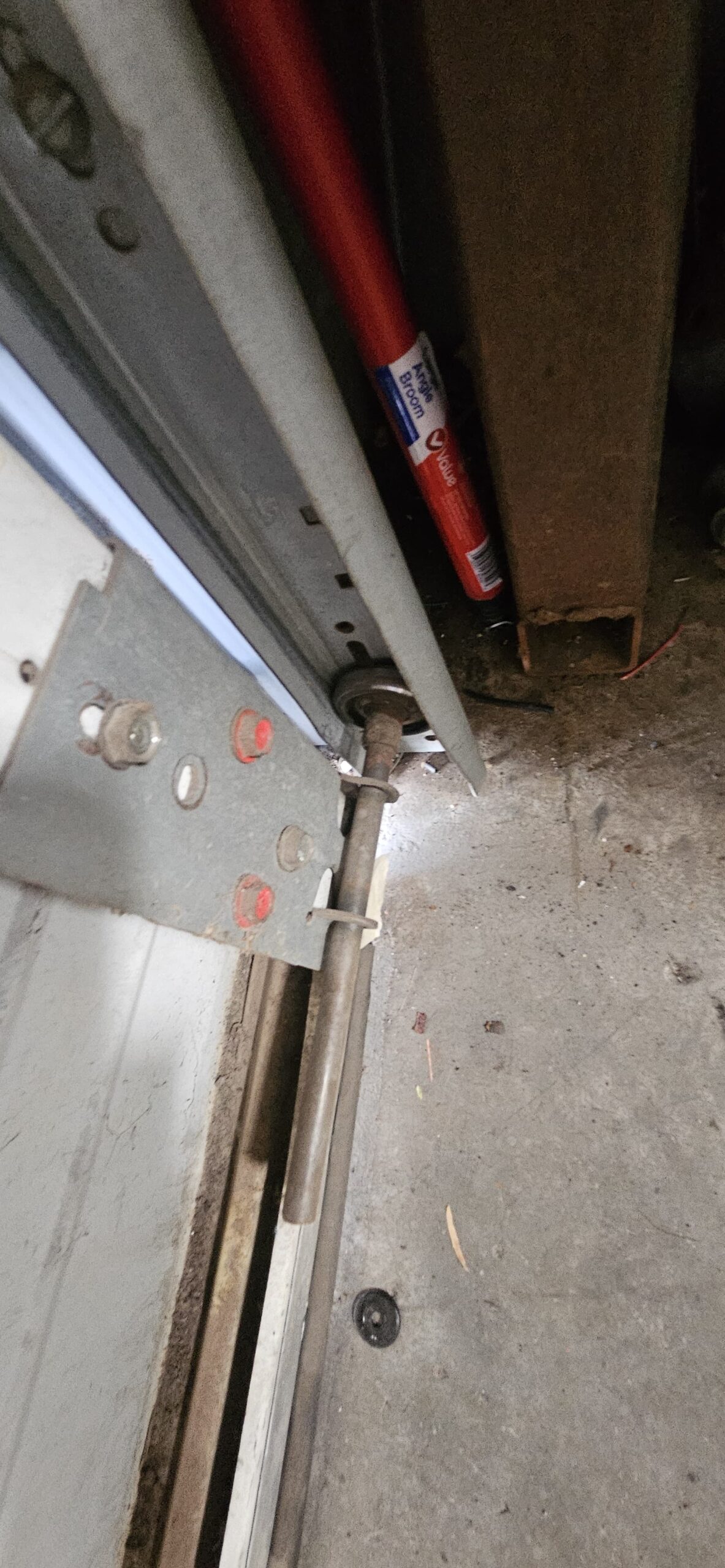 Existing commercial garage door roller in the track before roller replacement