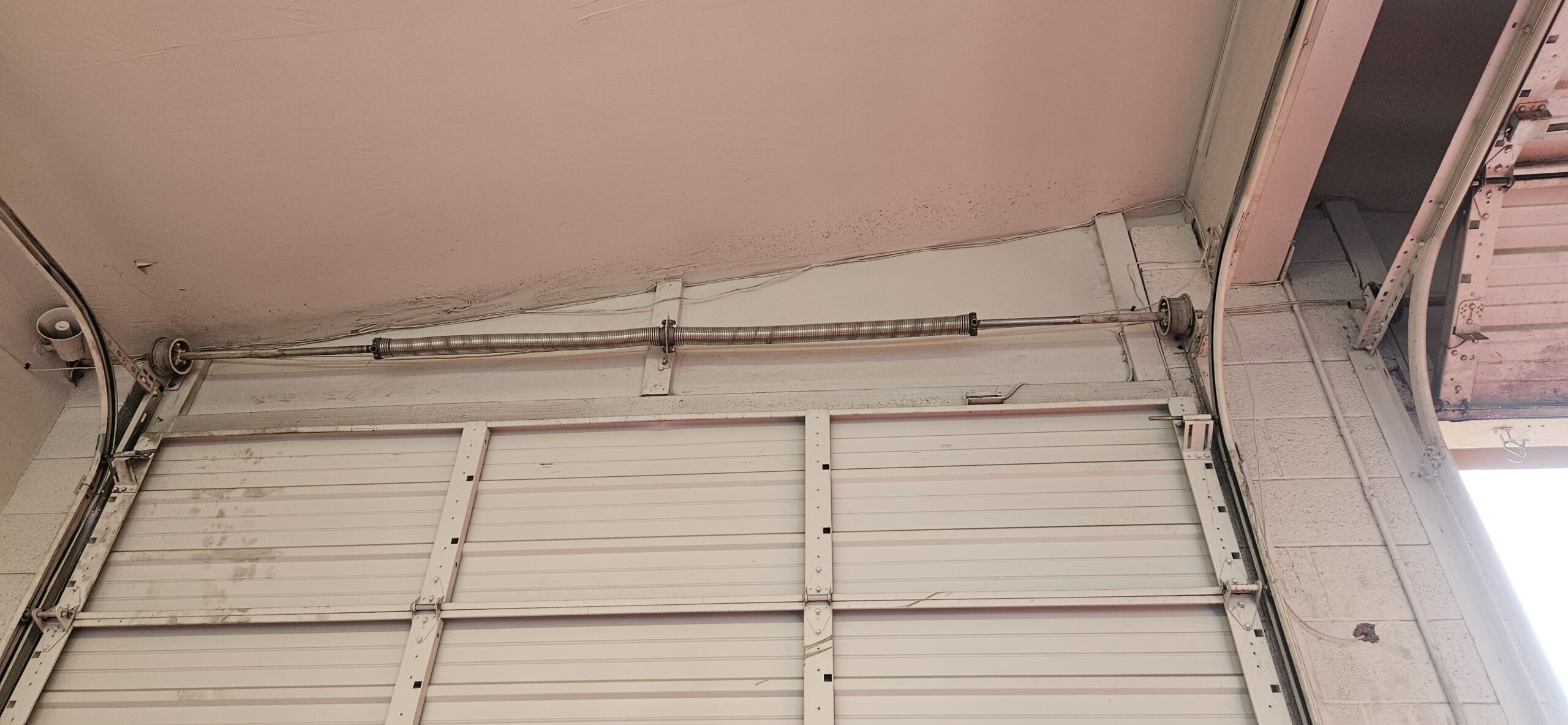 Recently installed commercial garage door spring system after adjustment in Phoenix
