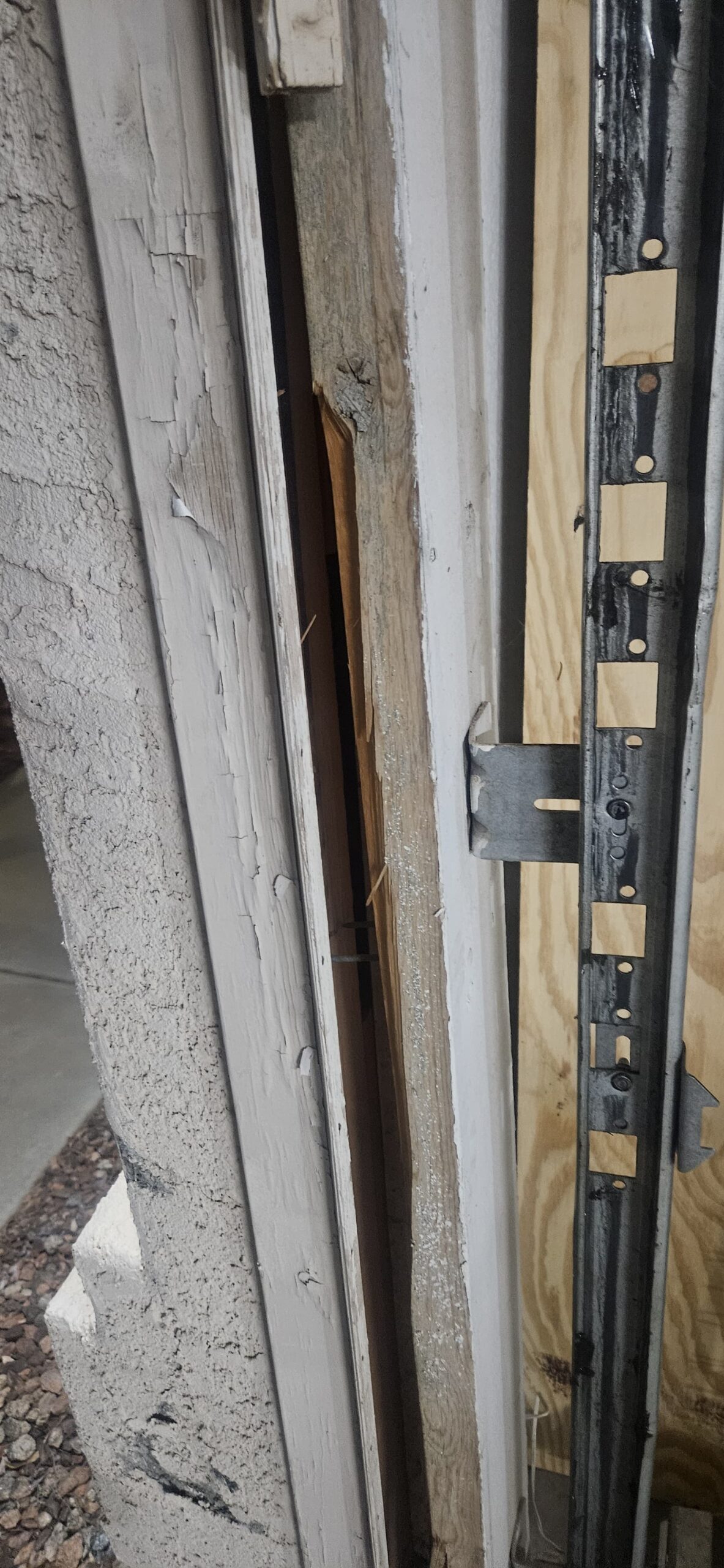 Close view of damaged garage door wood frame on W Monte Vista Rd in Avondale