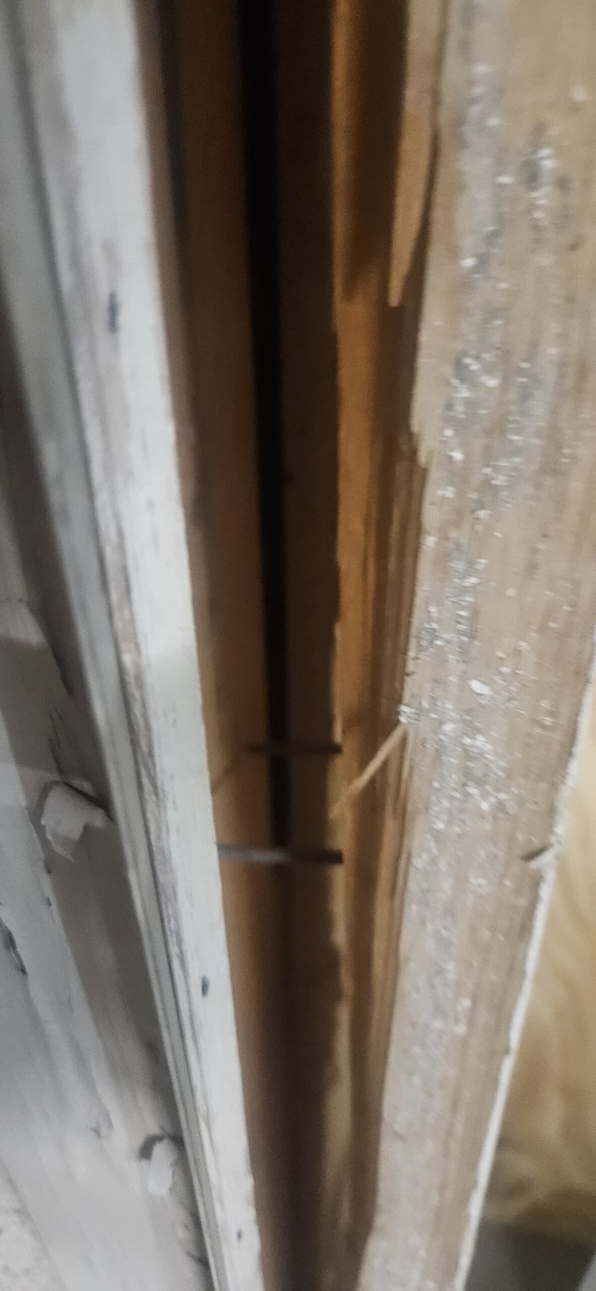 Damaged wooden garage door frame pulled apart before repair on W Monte Vista Rd in Avondale