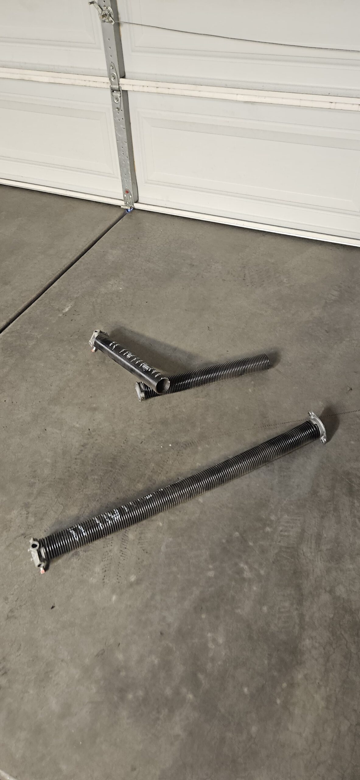 Broken garage door spring before repair on W Joblanca Rd in Avondale Arizona