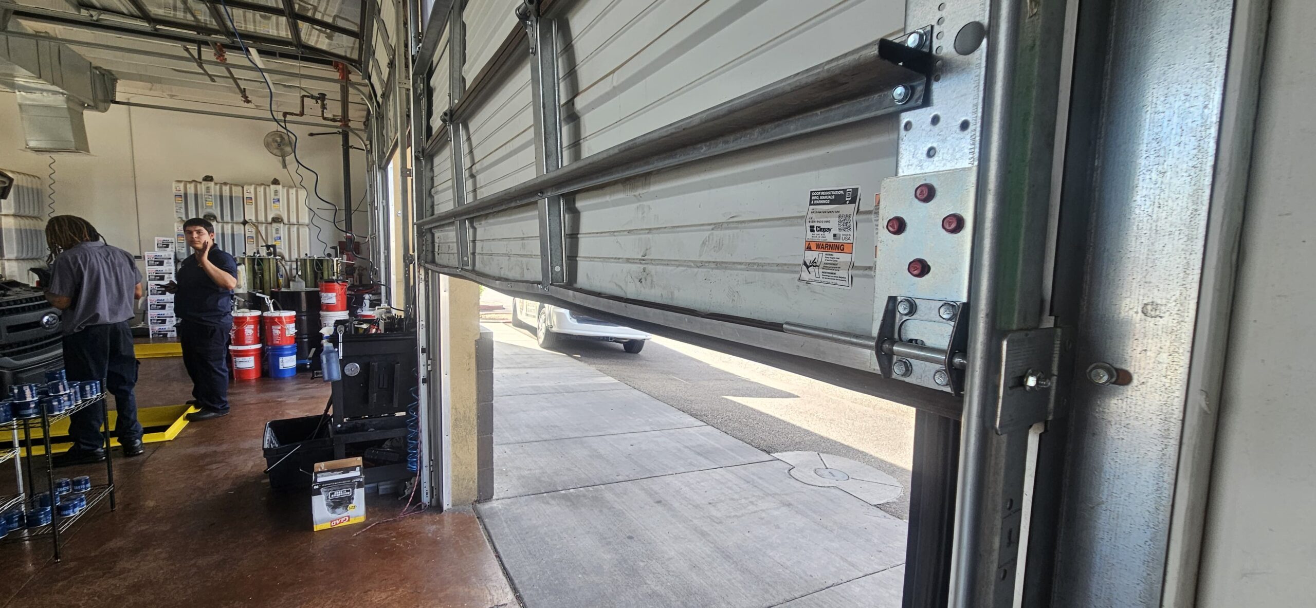 Reinforced lower commercial garage door section after repair in Phoenix