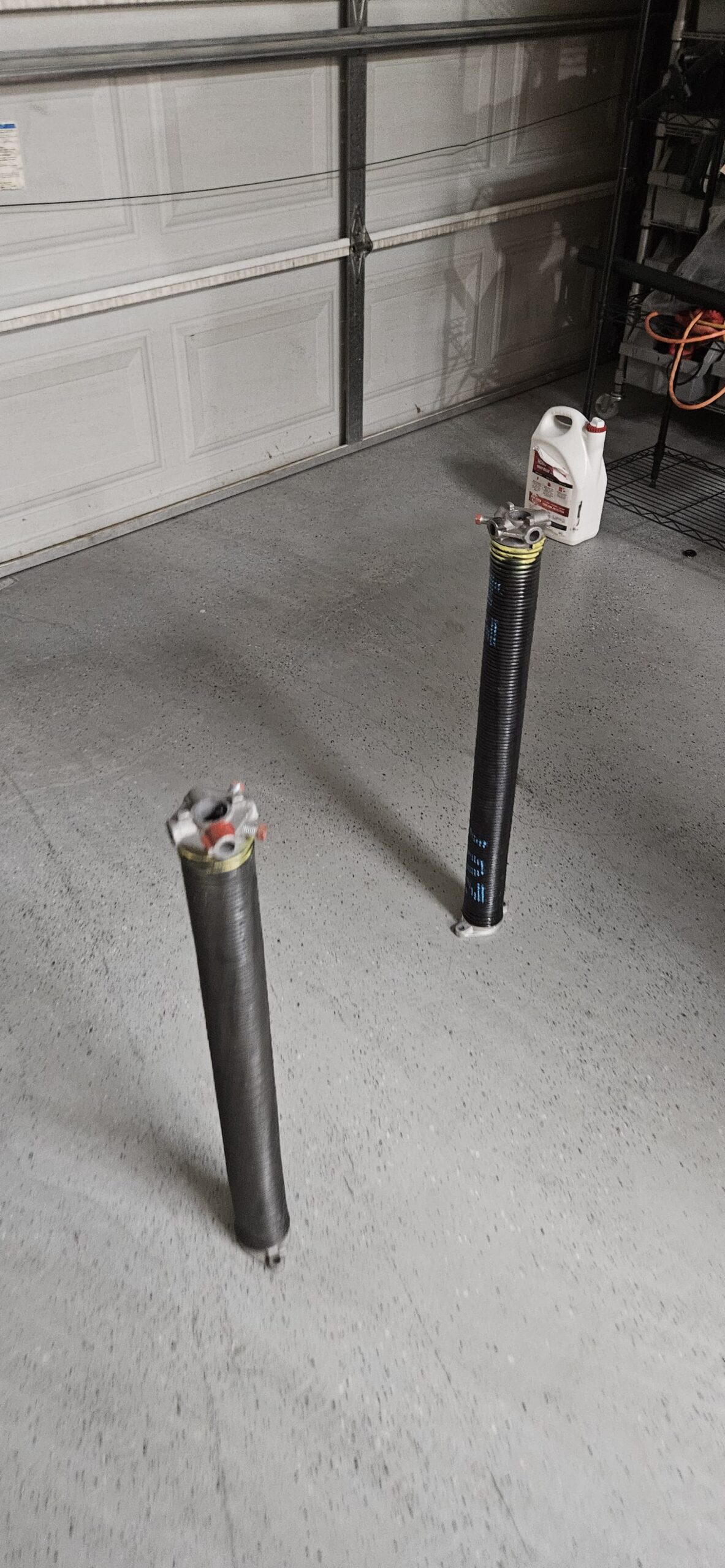 New and old garage door springs from repair on W Windsor Ave in Avondale Arizona