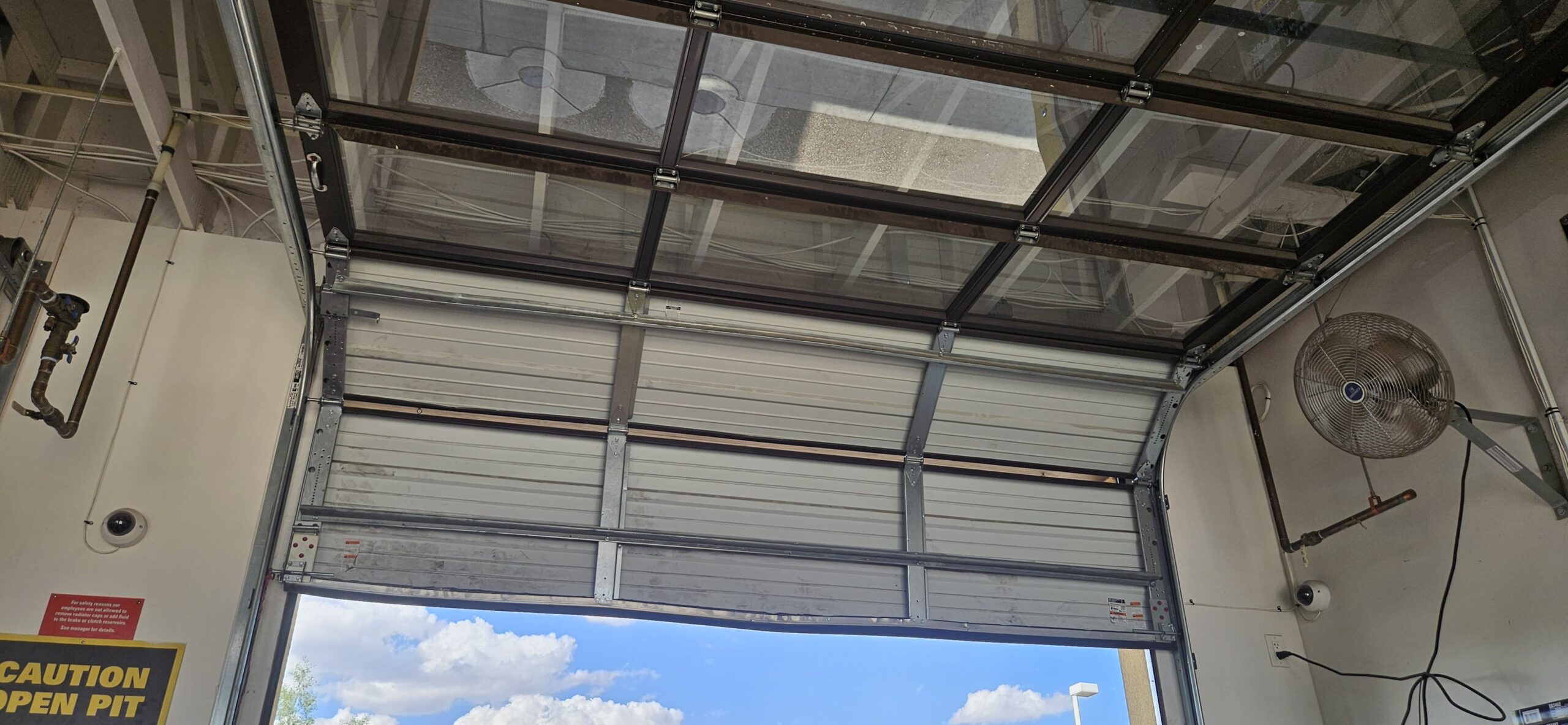 Take 5 Oil Change commercial garage door after panel repair in Phoenix