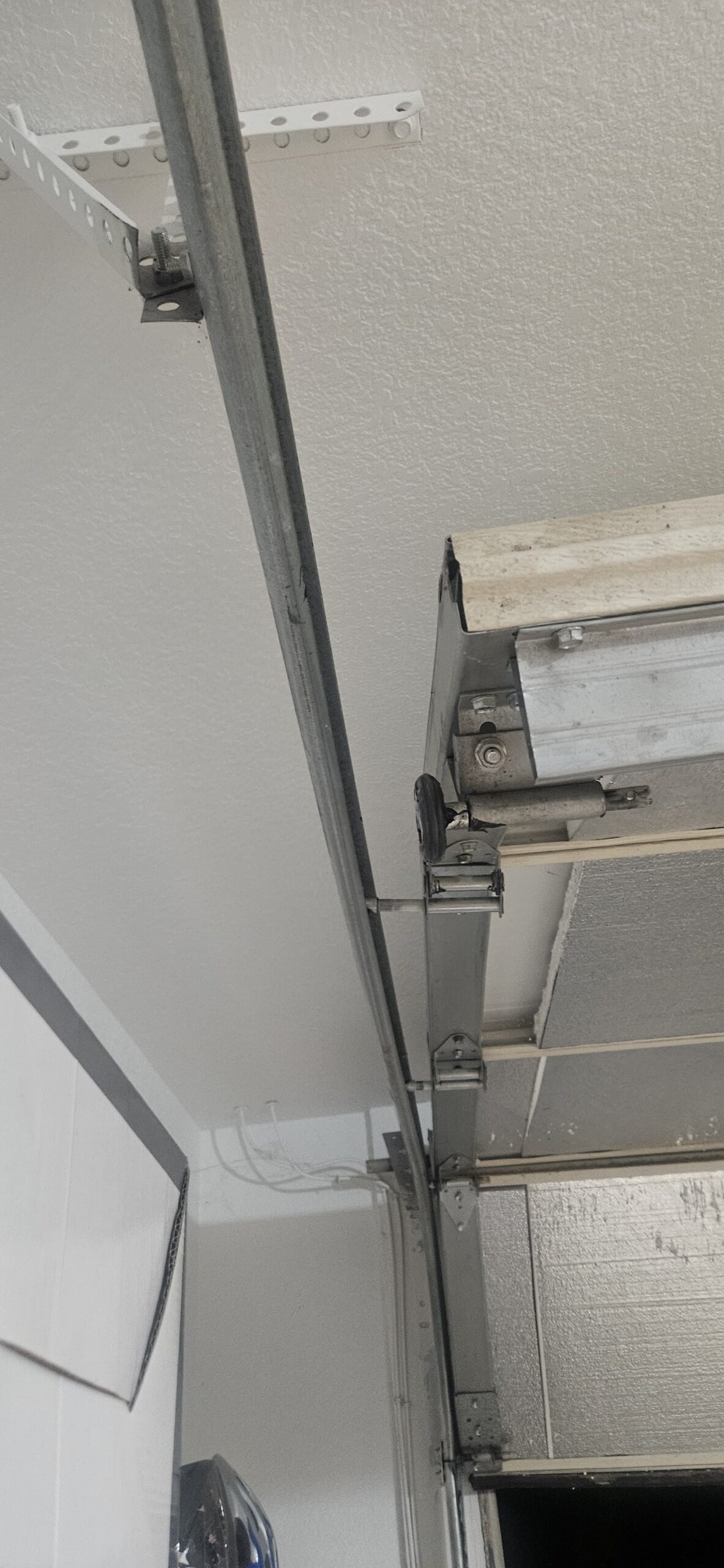 Garage door roller out of position before frame repair on W Monte Vista Rd in Avondale Arizona