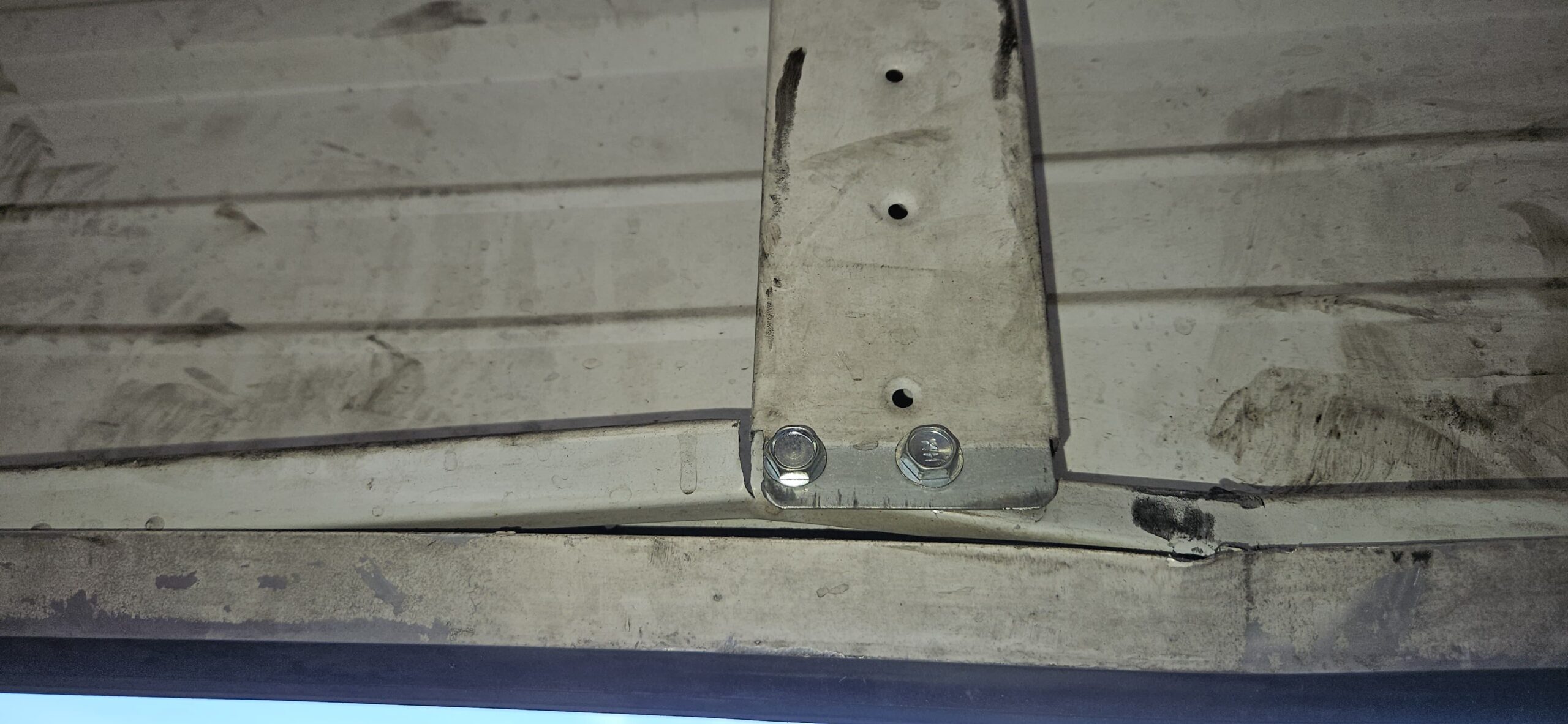 Lower section of commercial garage door reinforced at Take 5 Oil Change on W Indian School Rd in Phoenix