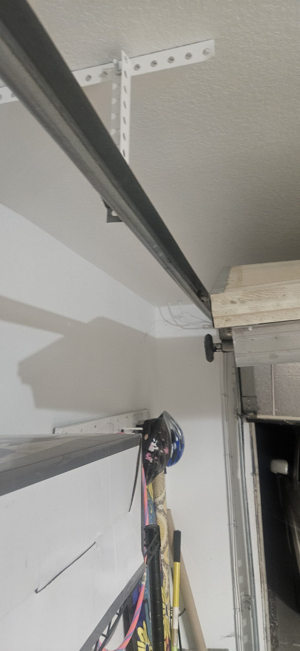 Garage door roller out of alignment before repair in Avondale